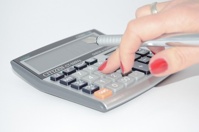 A woman using calculator to prepare a budget