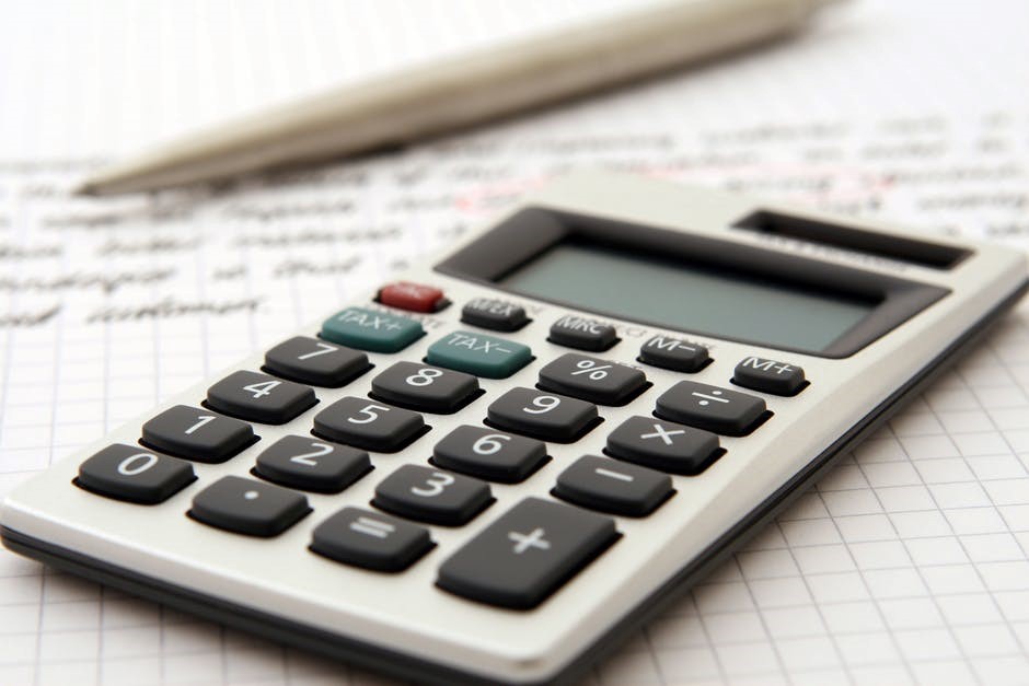 Calculator and a pen to prepare a budget