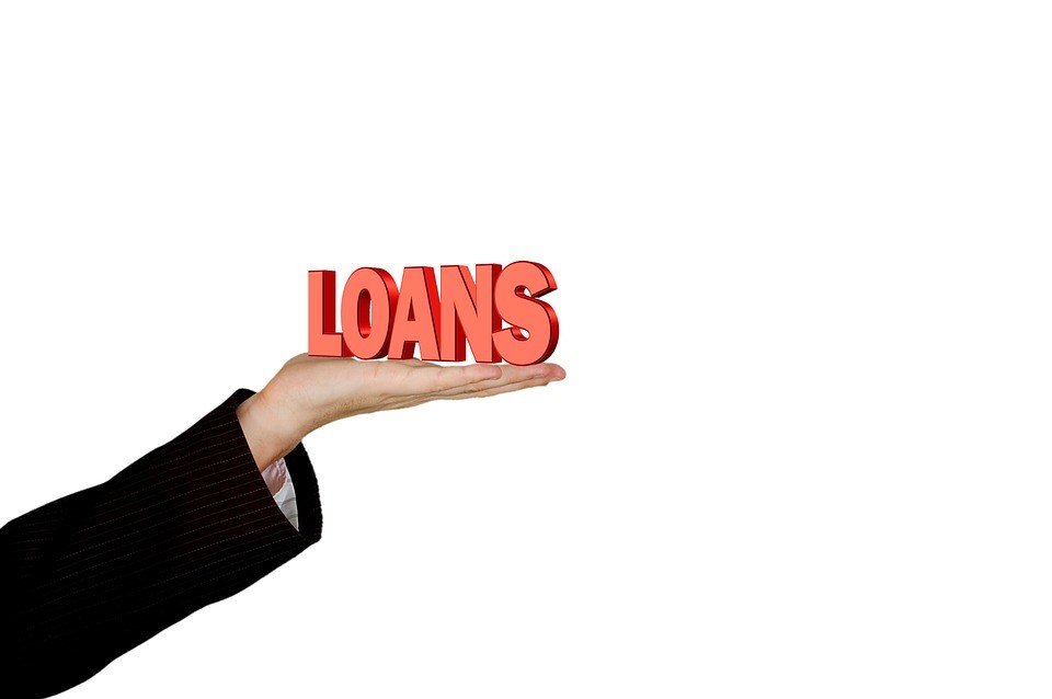 person holding up a loans sign