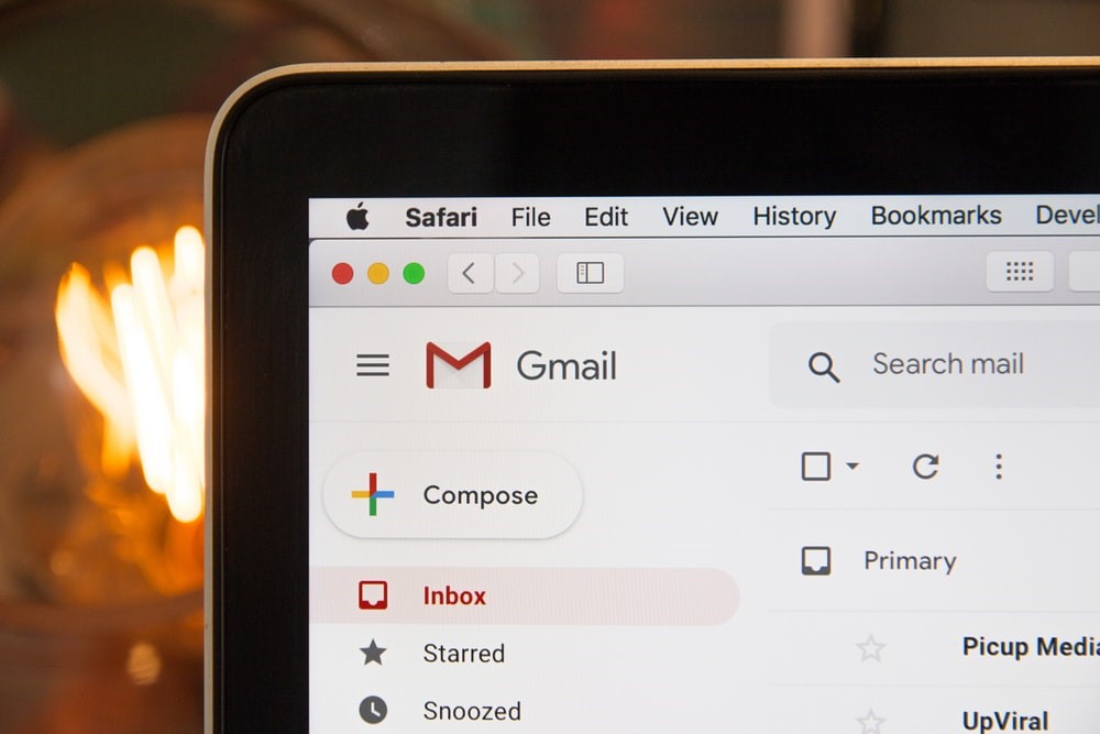 left corner of black laptop screen showing Gmail inbox in Safari